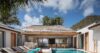 Courtyard pool surrounded by sun loungers and dining areas at a luxury villa rental in St Barts