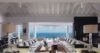 Spacious living room in luxury St Barts villa with ocean view through wide open windows