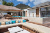 Luxury St Barts villa terrace with sun loungers, infinity pool, and shaded outdoor lounge