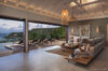 Elegant open-air living room with terrace lounge chairs and ocean views at a luxury St Barts villa
