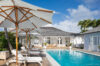 Sunny pool terrace with loungers, umbrellas, and classic Caribbean-style villa in St Barts rental