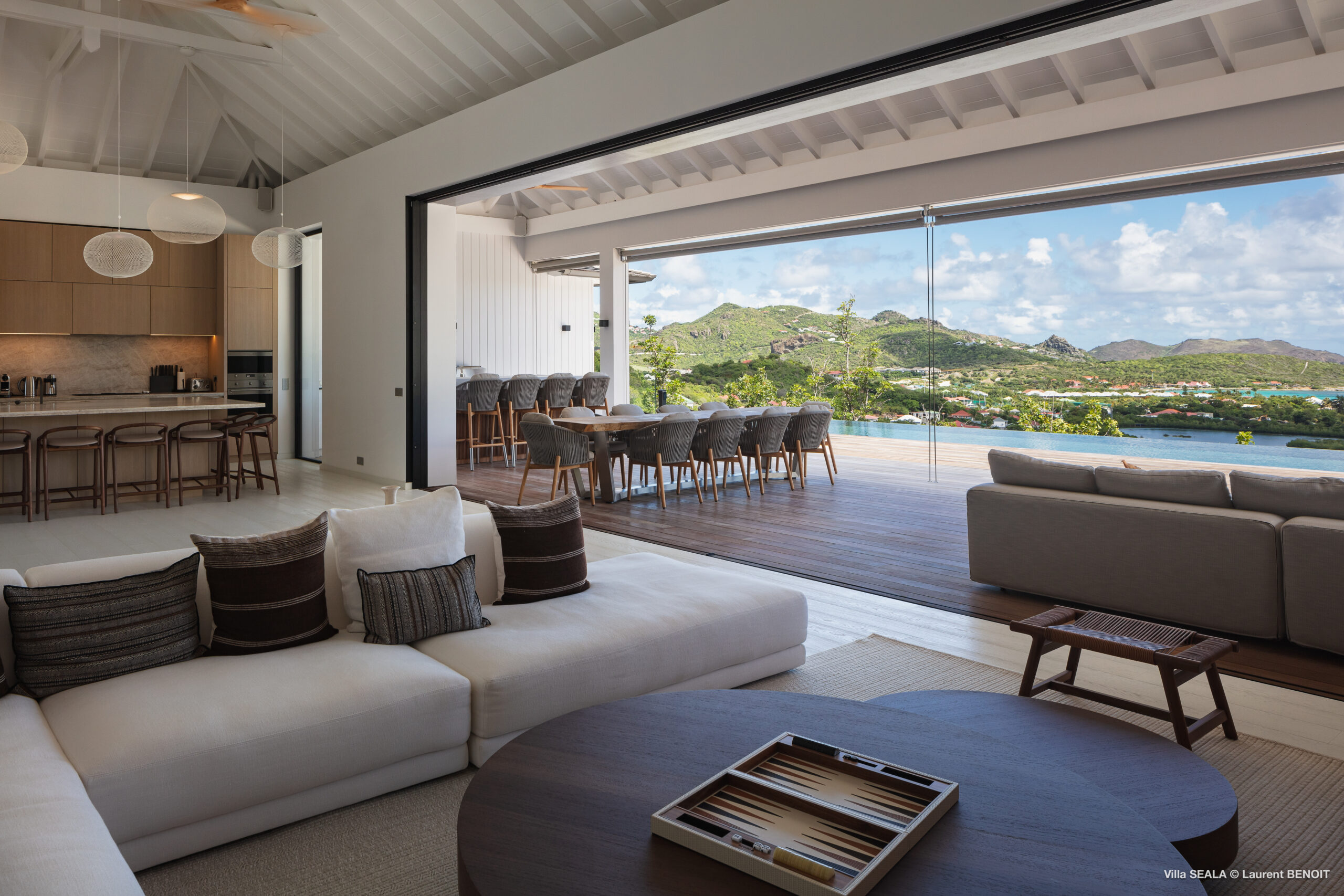 Spacious open-plan living room with kitchen and terrace dining area at a luxury villa in St Barts