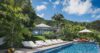 Private pool surrounded by sun loungers and tropical gardens at a luxury St Barts villa rental