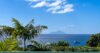 Panoramic ocean view from St Barts villa with tropical palms, distant island, and luxury yacht, private villa rental