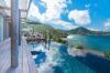 St Barts villa with infinity pool and wooden terrace overlooking lush green hills