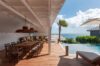 Shaded outdoor dining area beside the pool with ocean views at a luxury villa in St Barths.