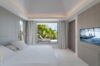 Bedroom with large windows offering a stunning view of the natural landscape