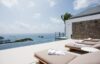 Sun loungers by an infinity pool at a St Barts villa with panoramic views of the Caribbean Sea and offshore islets.