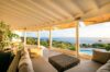 Covered lounge with plush seating and panoramic ocean view at luxury villa rental in St Barts