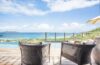 Cozy lounge chairs facing the infinity pool and ocean at a luxury St Barts villa