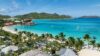 Aerial view of St Barts coastline with turquoise waters, sandy beach, and anchored yachts.