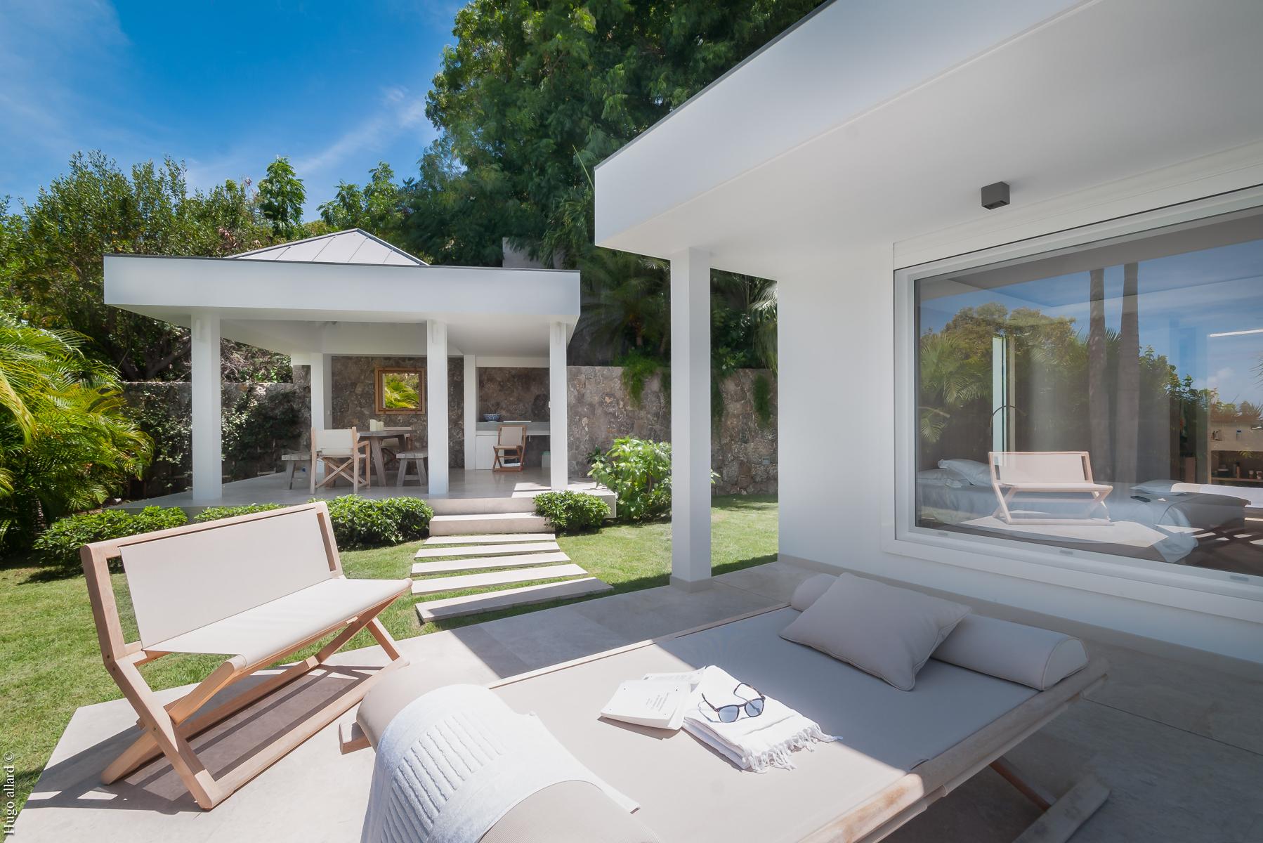 Scenic view of an infinity pool surrounded by lush vegetation, creating a peaceful natural retreat.