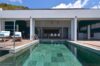 Infinity pool at St Barts villa with panoramic ocean views and modern deck seating.