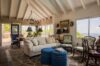 Traditional living room with vaulted ceiling, vintage furniture, and terrace access at St Barts villa rental