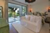Elegant bedroom in St Barts villa with garden view, modern lighting, and private terrace access.