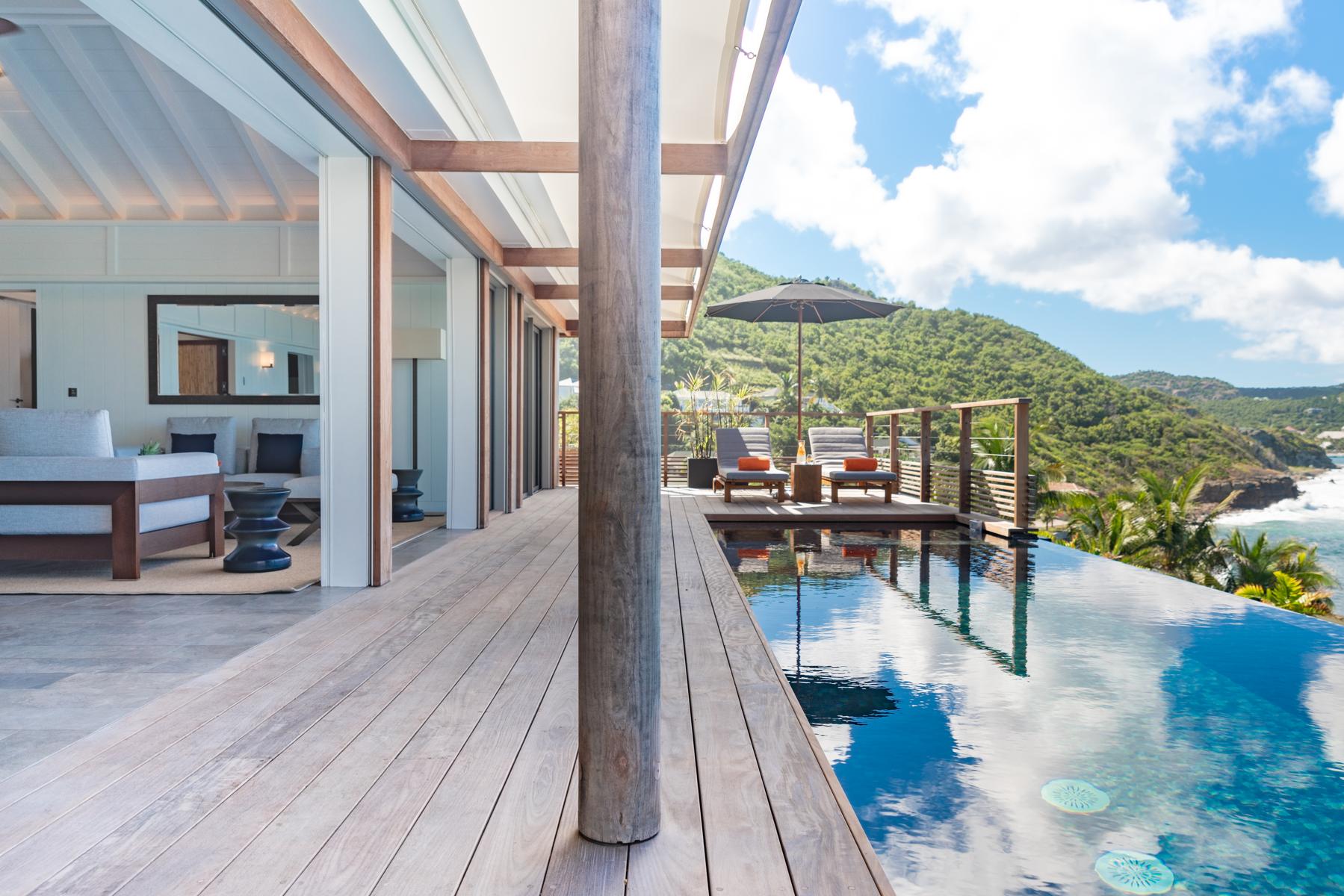 Private deck at St Barts villa with sun loungers overlooking Caribbean coastline
