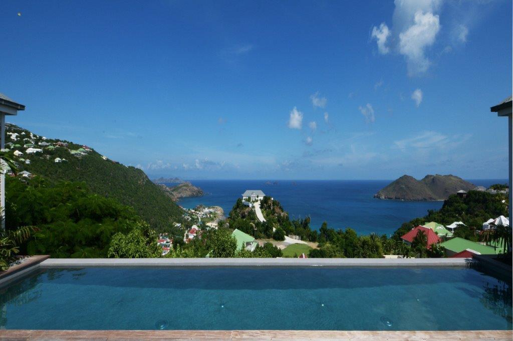 Infinity pool with panoramic hillside and ocean views from a St Barts luxury villa rental