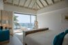 Serene bedroom in a St Barts villa with oceanview terrace, vaulted ceiling, and modern décor in soft neutral tones.