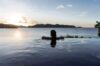 Guest enjoying infinity pool at St Barts villa with sunset ocean views