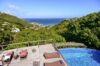 Deck with loungers at vacation rental St Barth overlooking infinity pool and ocean”
