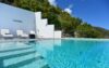 Infinity pool with panoramic ocean view and tropical hillside backdrop at luxury villa in St Barts