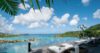 Infinity pool at a luxury St Barts villa with sun loungers overlooking turquoise bays and rolling green hills