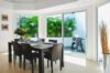 Bright dining room at St Barts villa with glass doors opening to garden terrace, vacation rental St Barths