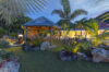 Tropical garden with gazebo and hammocks illuminated at night in a private St Barts villa rental.