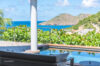 Shaded terrace dining area with pool and ocean view at a St Barts villa rental