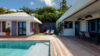 Private pool with wooden deck, shaded dining terrace, and sun loungers in a tropical St Barts villa rental.
