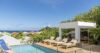 Poolside deck with sun loungers and shaded cabana overlooking the sea at St Barts vacation rental