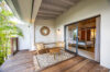 Private terrace at Villa Jocapana with lounge chairs and sliding doors opening to bedroom.
