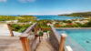 Wooden deck staircase leading to infinity pool with sweeping ocean views in St Barts.