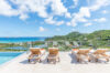 Sun loungers lined up by an infinity pool with panoramic views of the Caribbean Sea in a St Barts villa rental.