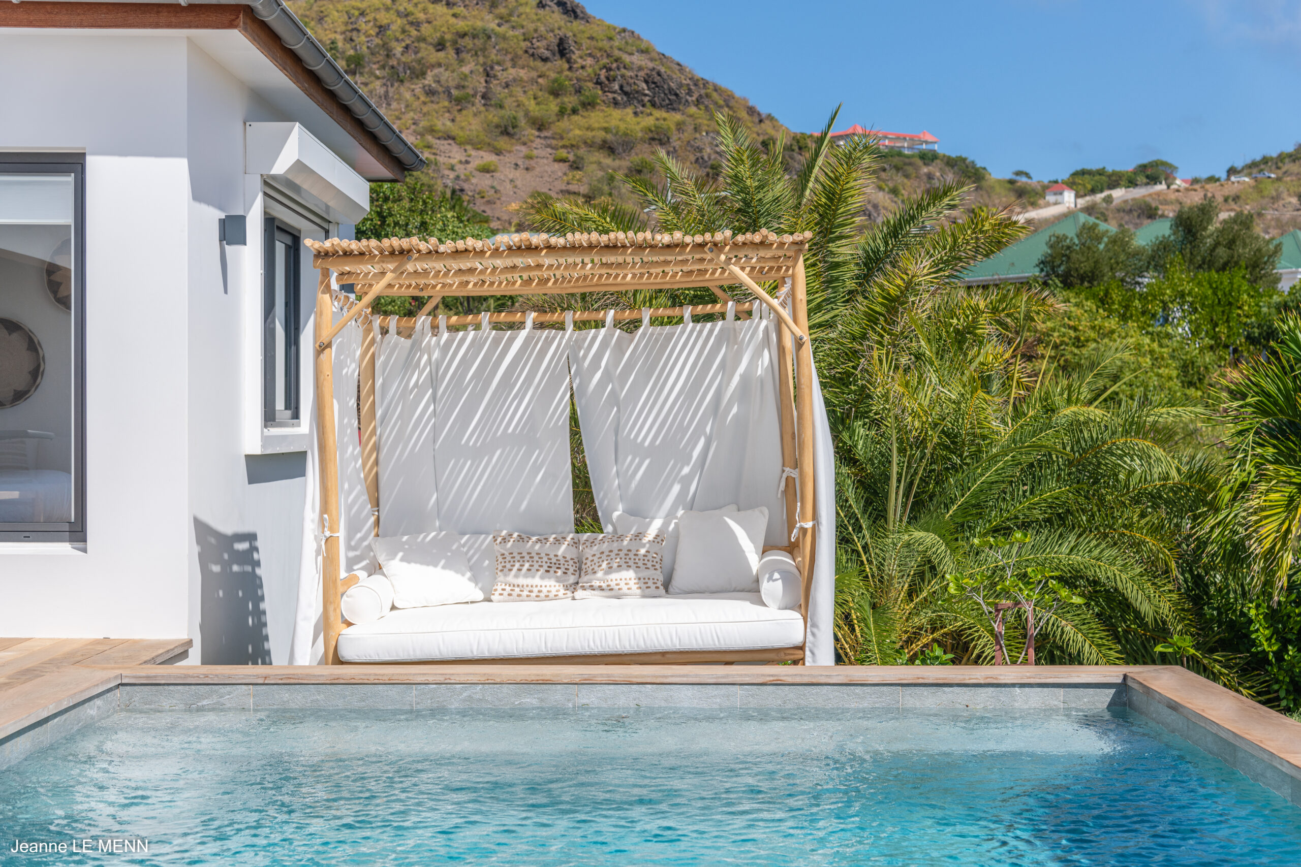 Private infinity pool at a St Barts villa overlooking the Caribbean Sea under clear blue skies.