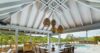 Covered outdoor dining area in a St Barts villa rental with pool views and vaulted ceiling.