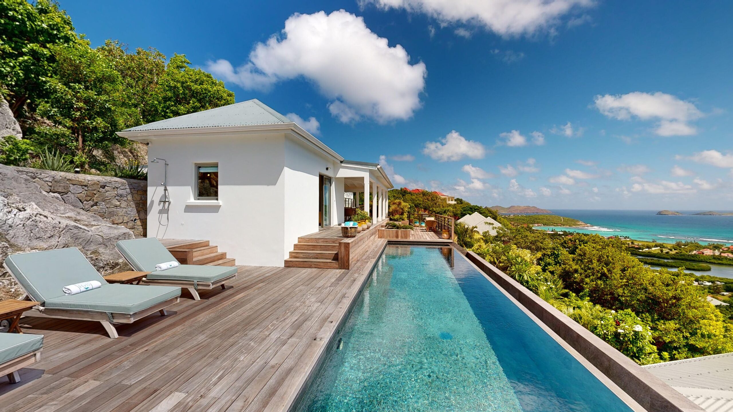 St Barts villa infinity pool glowing at dusk with panoramic views of the Caribbean horizon.