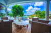 Luxury villa poolside deck in St Barts with panoramic ocean views and loungers.