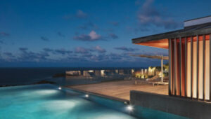 Luxury St. Barts villa with infinity pool and ocean view at dusk.