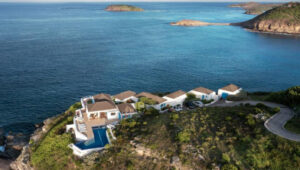 Elegant cliffside villa in St. Barts overlooking the Caribbean Sea, featuring an infinity pool